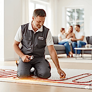 "Deha Enerji teknisyeni, modern bir evde yerden ısıtma borularını kontrol ederken görülüyor. Arka planda konforlu bir şekilde oturan aile, Deha Enerji'nin satış sonrası düzenli destek ve güvenilir hizmet anlayışını simgeliyor."